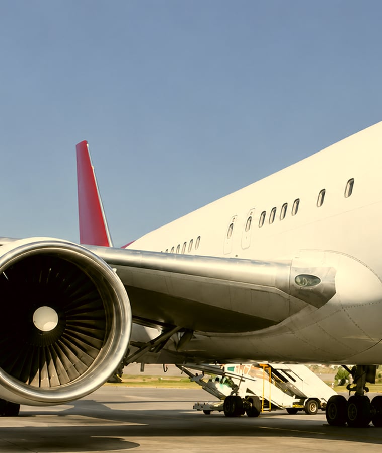 Cargo being loaded through the side door of a passenger jet, reflecting ACL Airshop's air cargo equipment and logistics services
