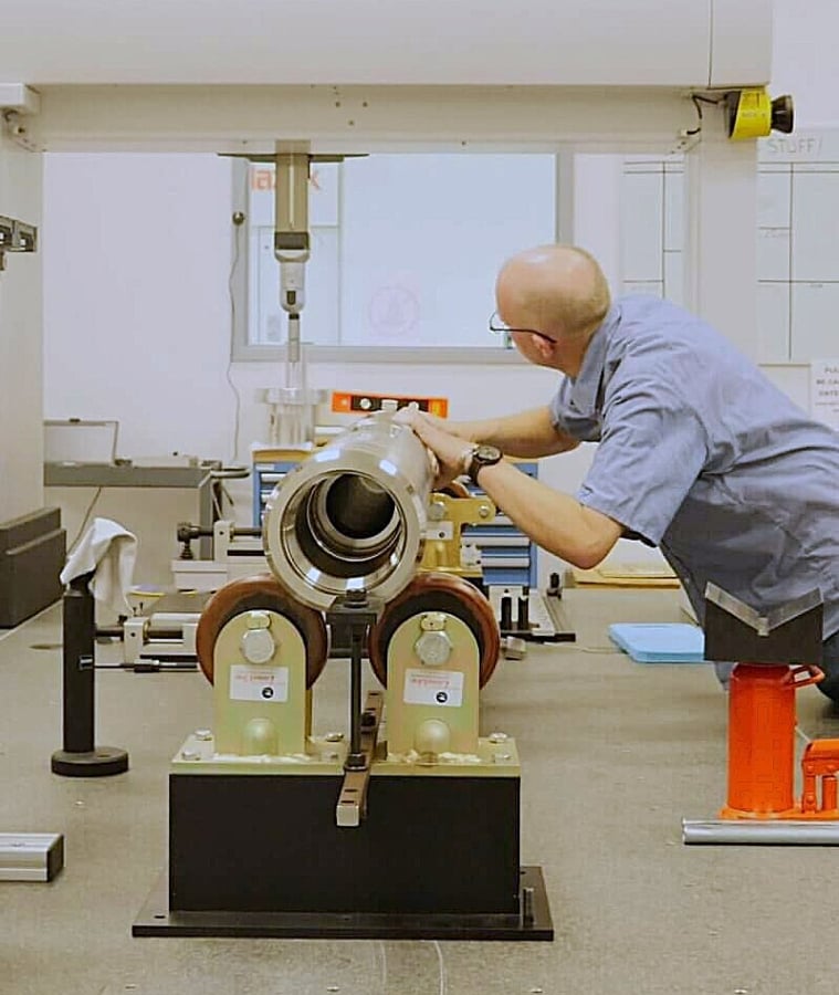 Engineer inspecting drilling tool components in a manufacturing lab