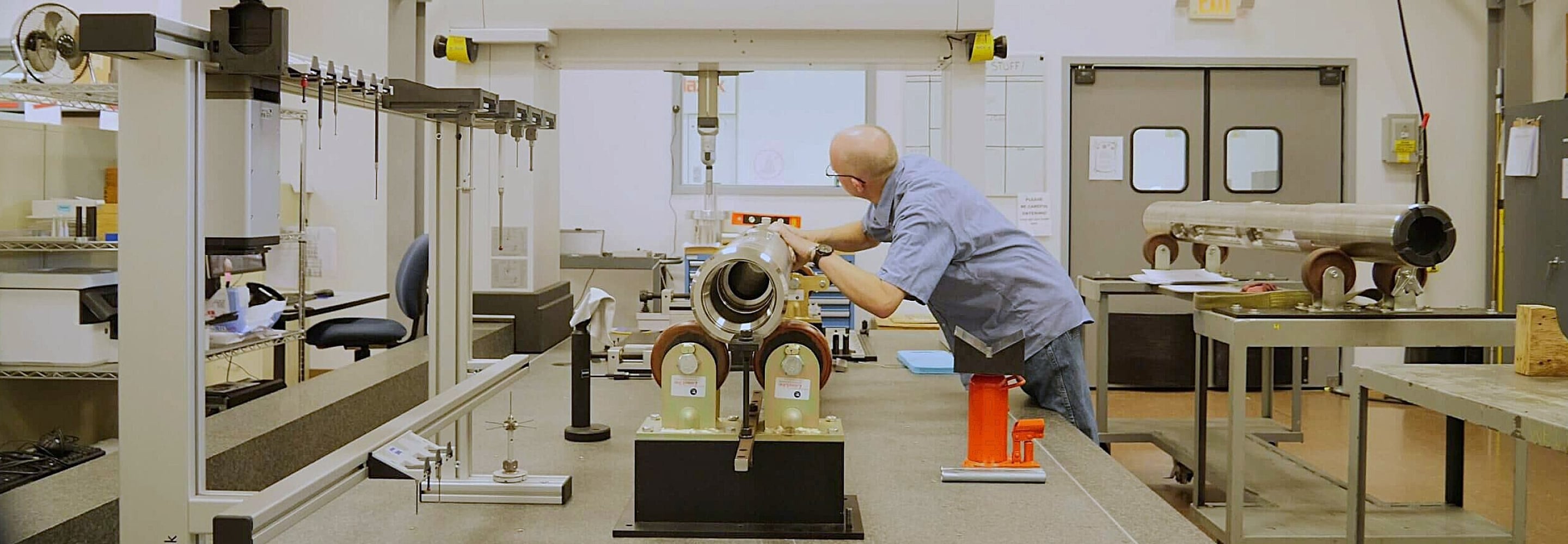 Engineer inspecting drilling tool components in a manufacturing lab