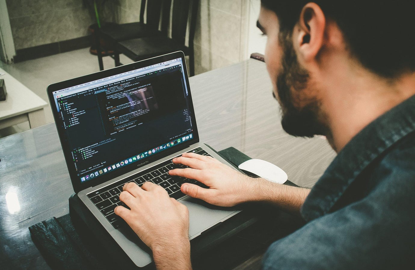 Software developer writing code on a laptop, representing Blankfactor's technology services