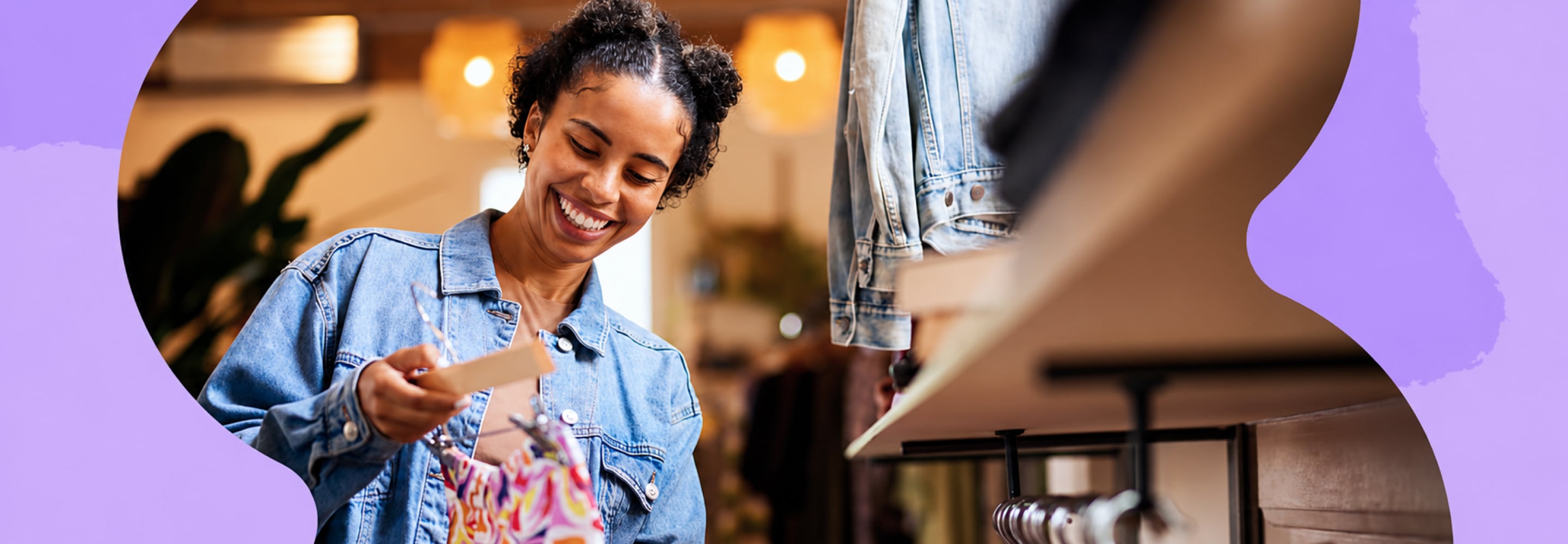 Smiling woman shopping for clothes and checking a price tag in a store