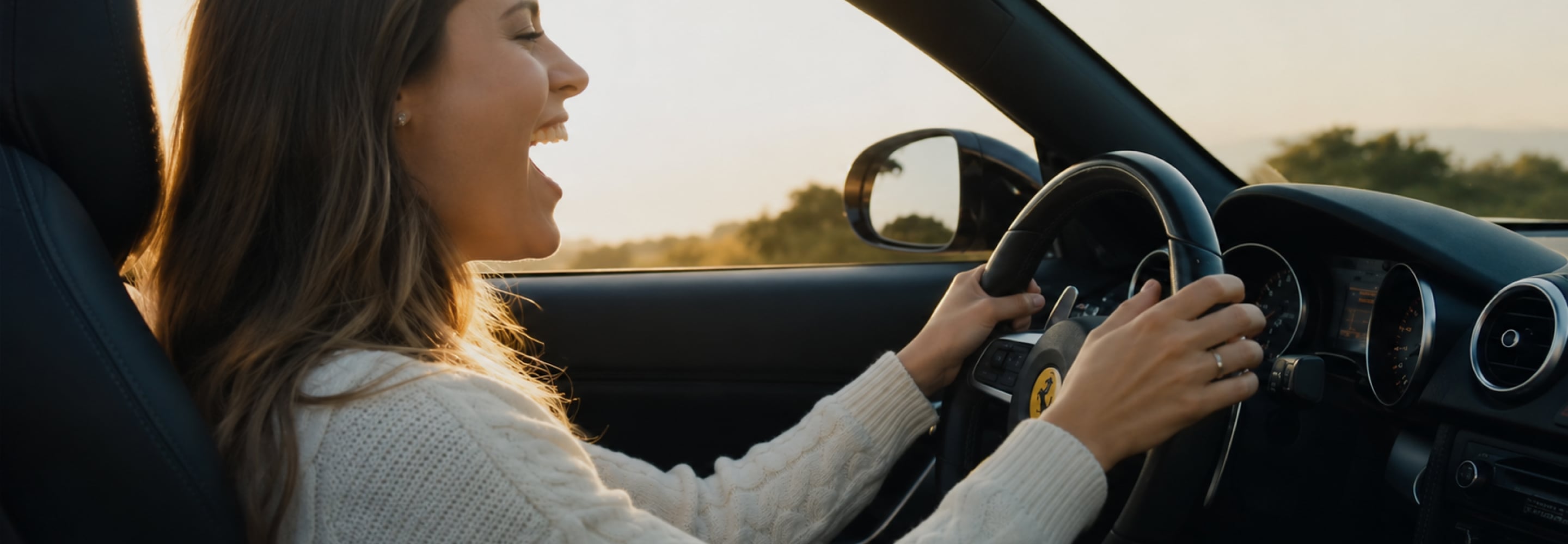 Woman laughing while driving a convertible, enjoying the radio