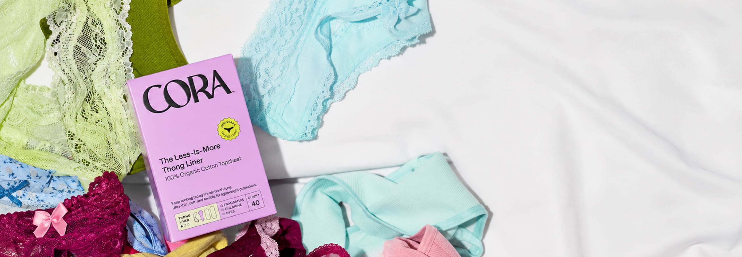 Cora period care box with colorful period underwear on a white surface