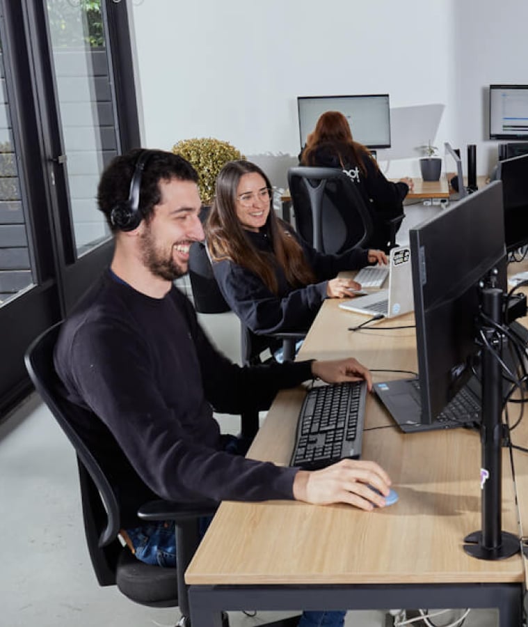 Software team working at computers in a collaborative office