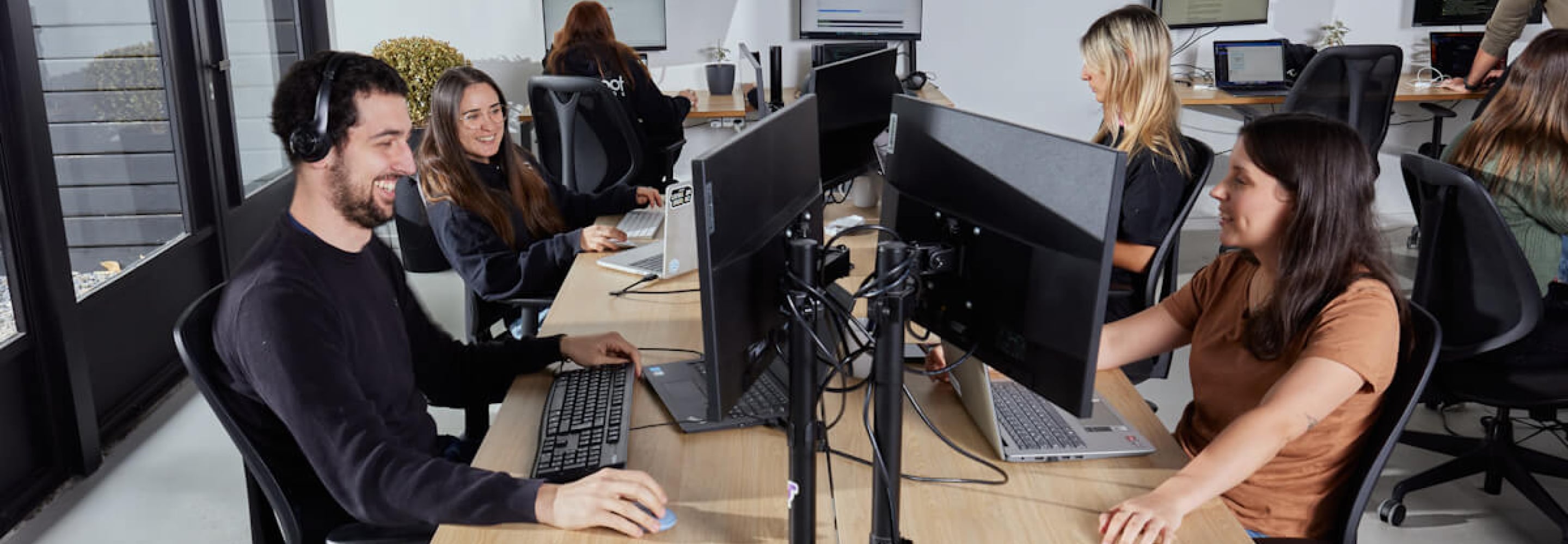 Software team working at computers in a collaborative office