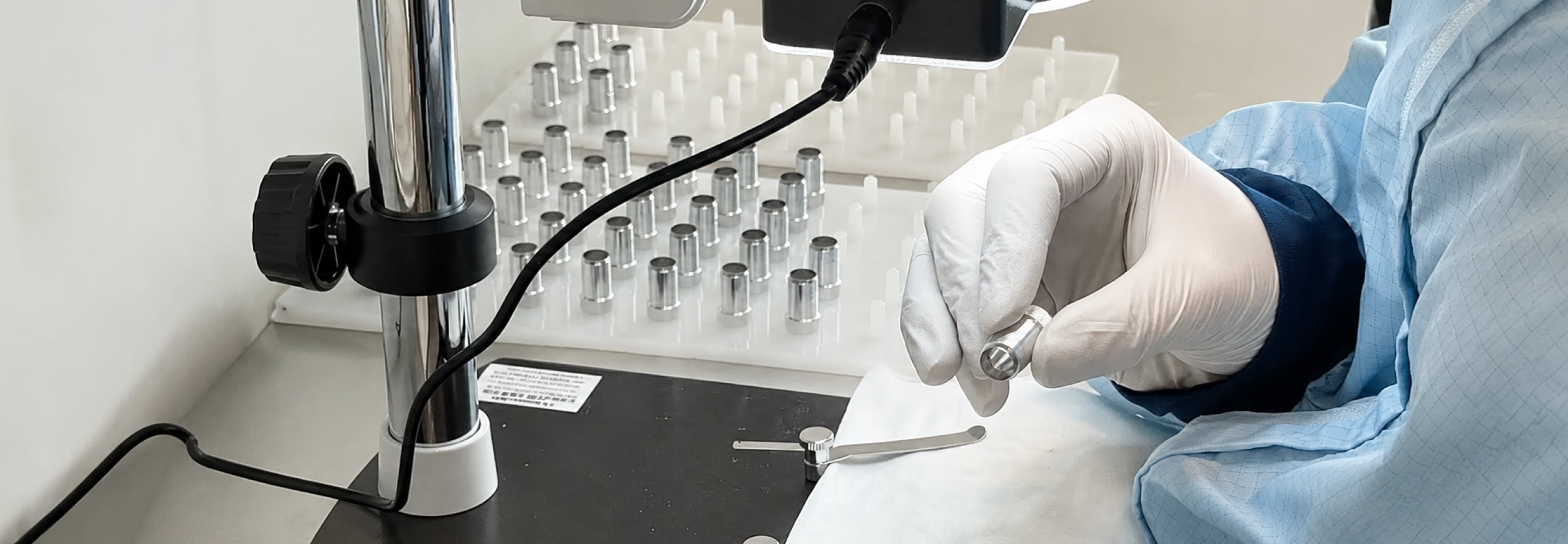 Gloved hand holding a single-use surgical instrument in a sterile setting