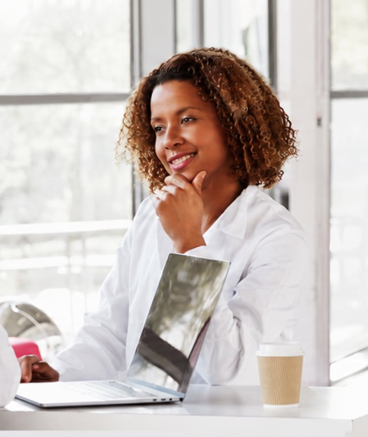 Clinical research professionals meeting around a table in a bright office