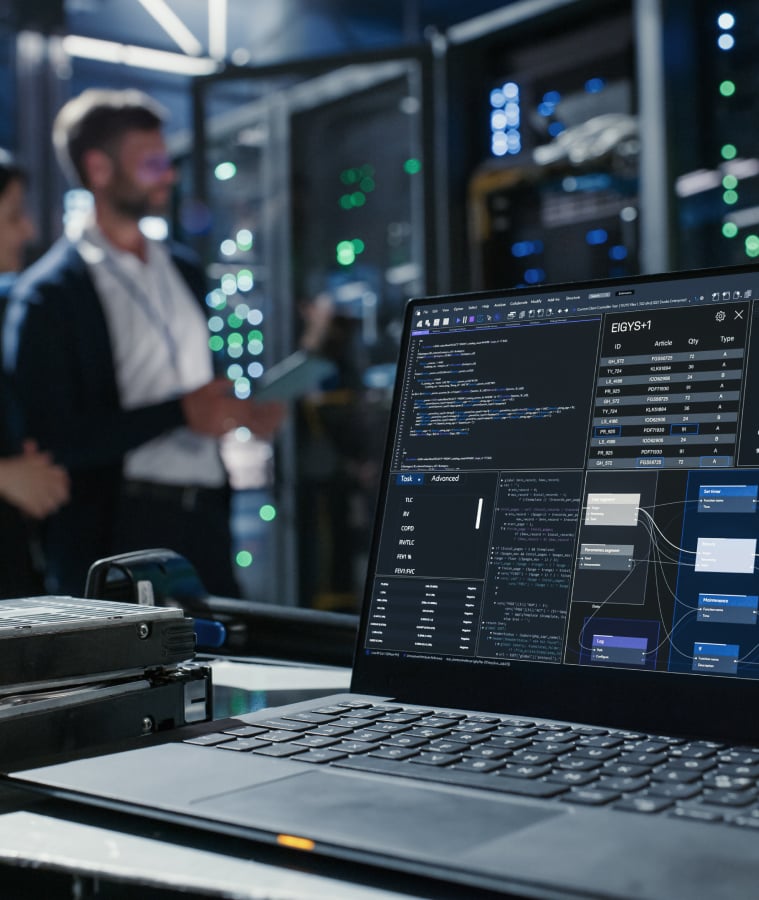 IT professionals working in a data center with server racks and a monitoring screen
