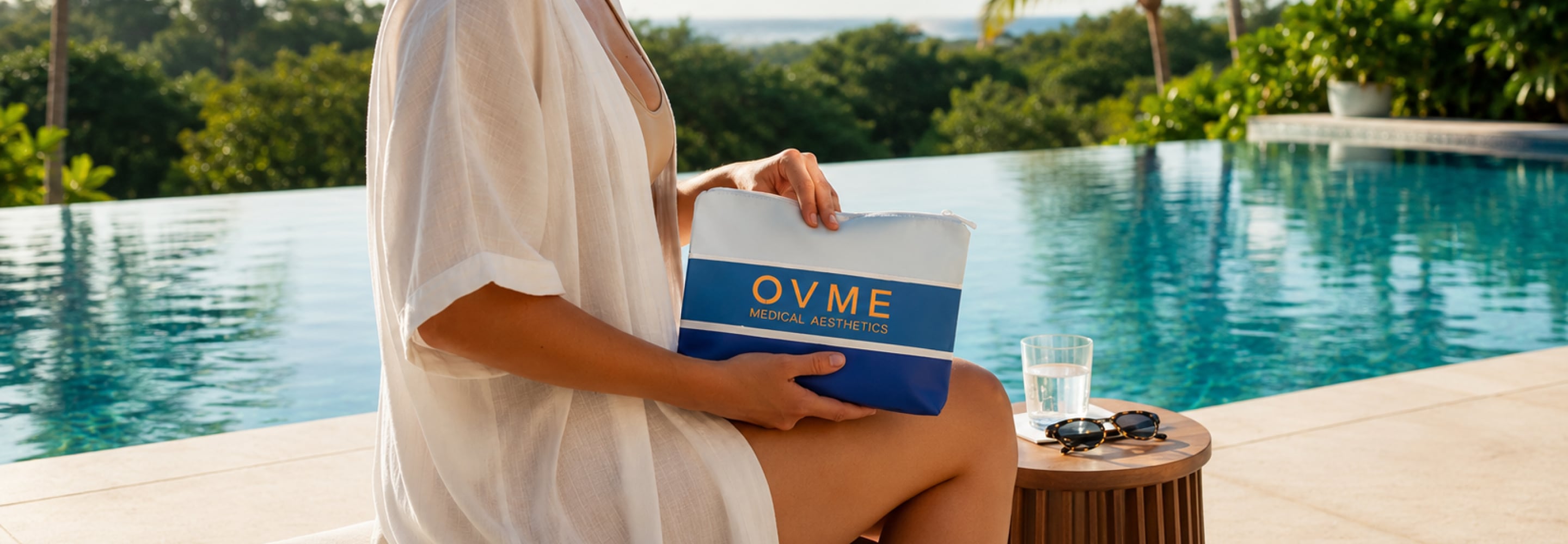 Woman relaxing poolside holding an OVME medical aesthetics bag