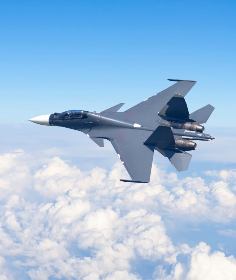 Fighter jet flying above the clouds