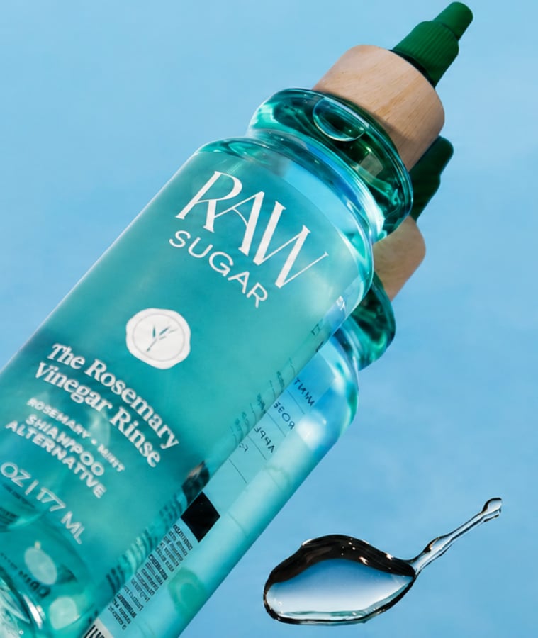 Bottle of Raw Sugar plant-based personal care product against a blue sky