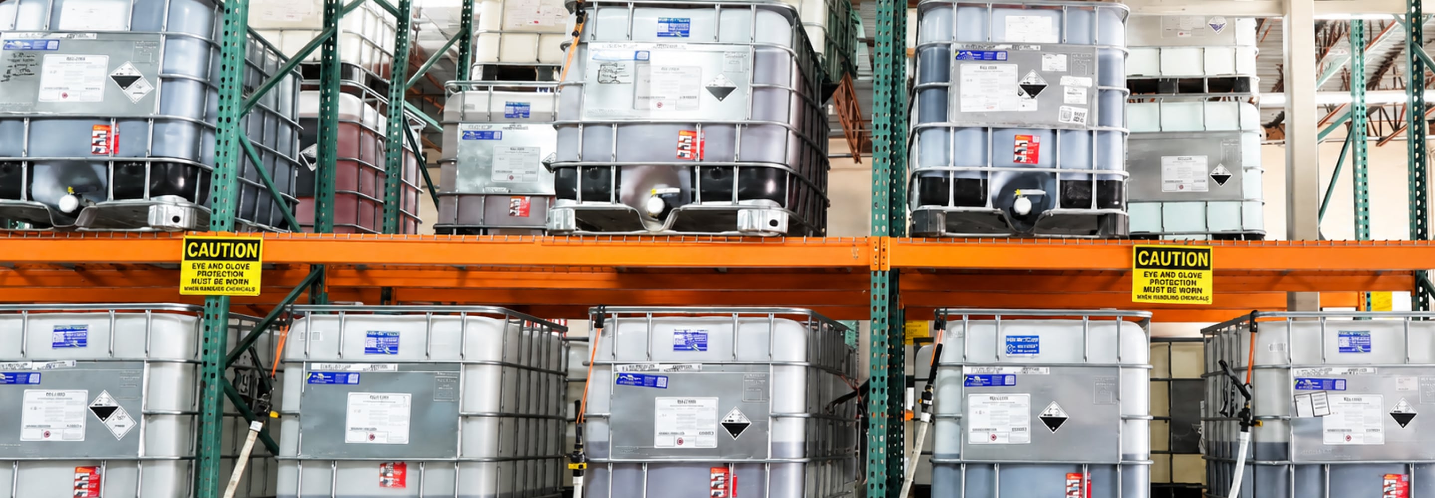 Industrial water treatment tanks stacked on warehouse shelving