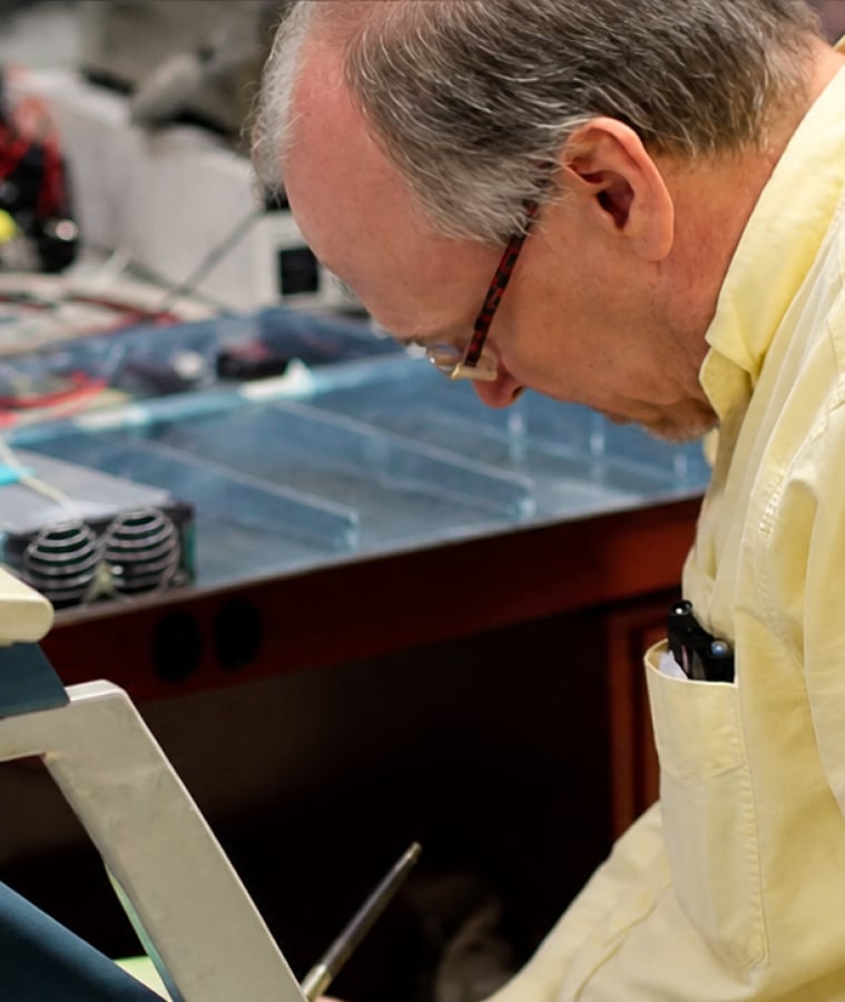Engineer testing power system components at a workbench