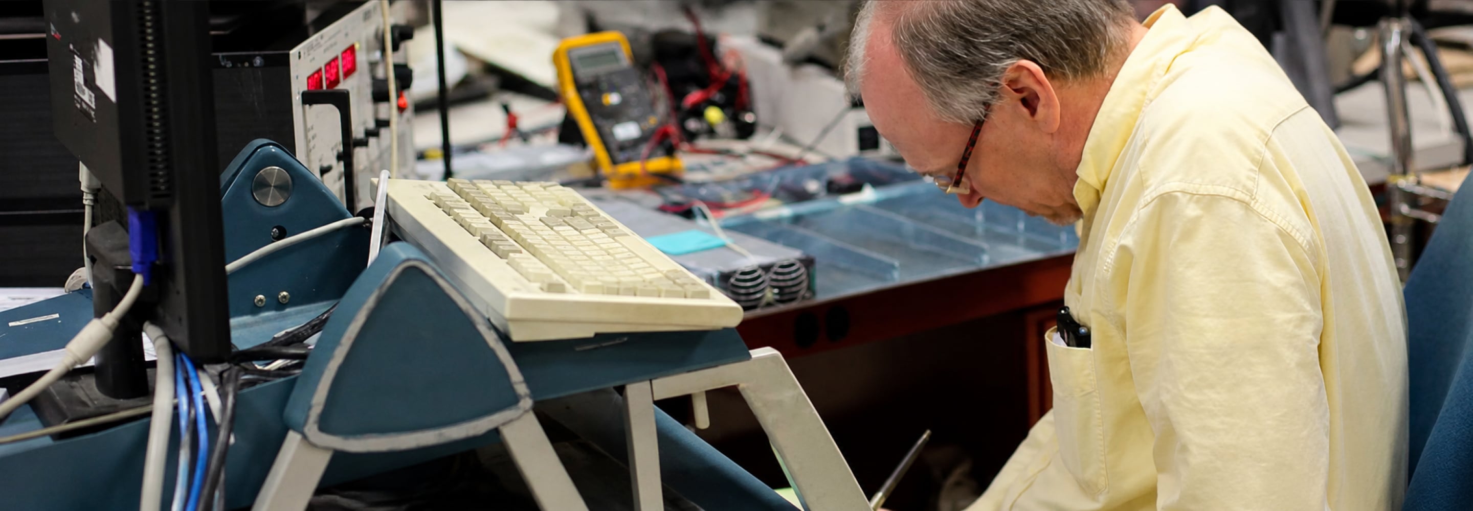 Engineer testing power system components at a workbench